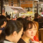 People drinking and eating at San Miguel market, Madrid.